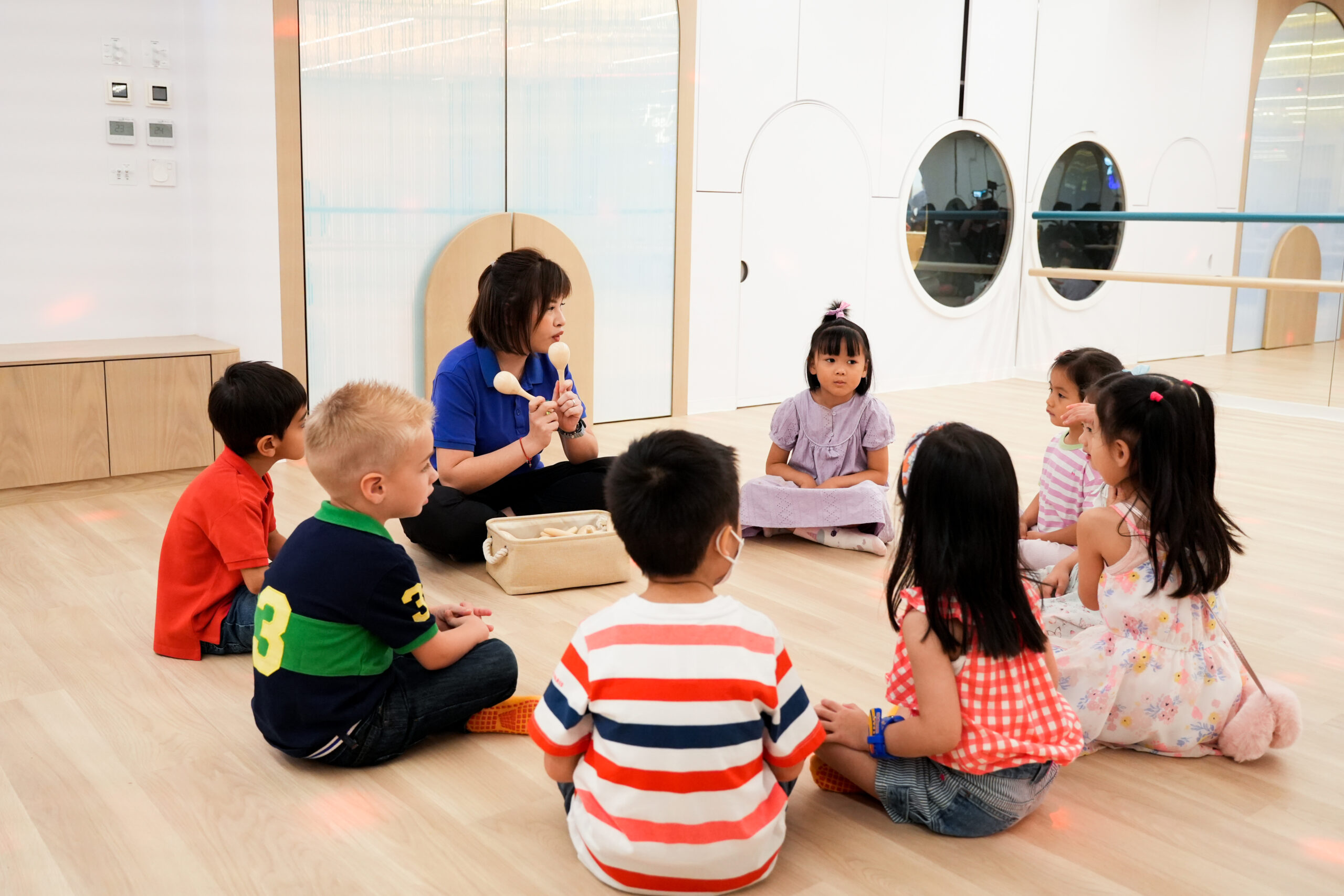 Kids moving and dancing together during a fun activity at Acorn Playhouse, Southside Hong Kong.