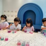 children doign stem experiment at Acorn Playhouse, an academic educational playhouse in Southside Hong Kong.