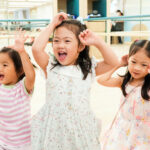 Children engaging in dancing activities at Acorn Playhouse, fostering creativity and learning through exploration.