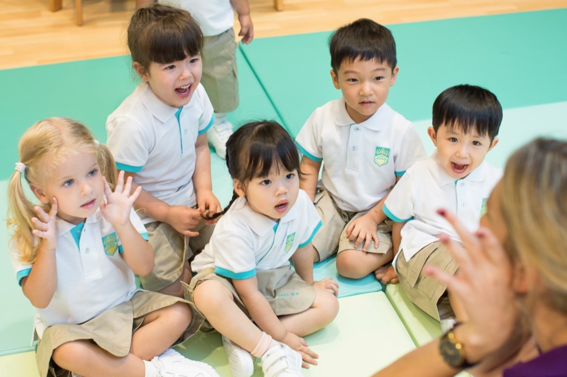 Award winning Mighty Oaks International Nursery Kindergarten students raising Hands